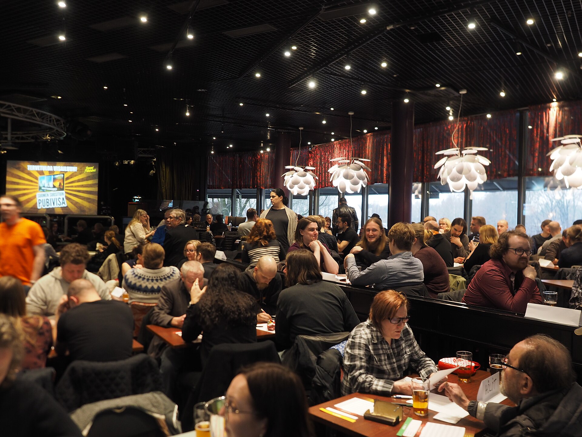 Illustrative photograph of groups participating in a pub quiz trivia contest; not a photograph of Pizzasaurus Rex