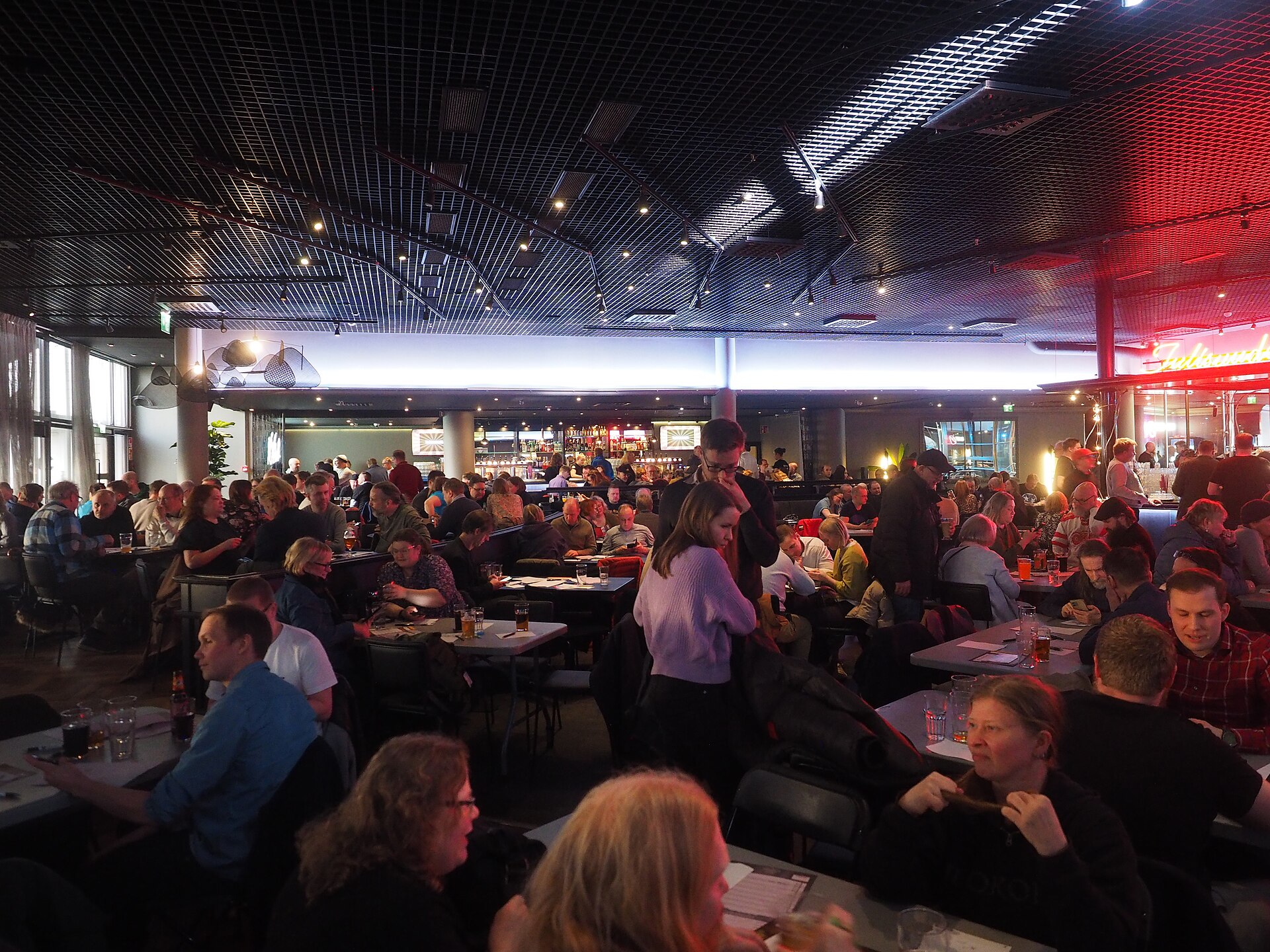 Illustrative photograph of teams playing a pub trivia quiz at tables; not a photograph of Lucid Winery