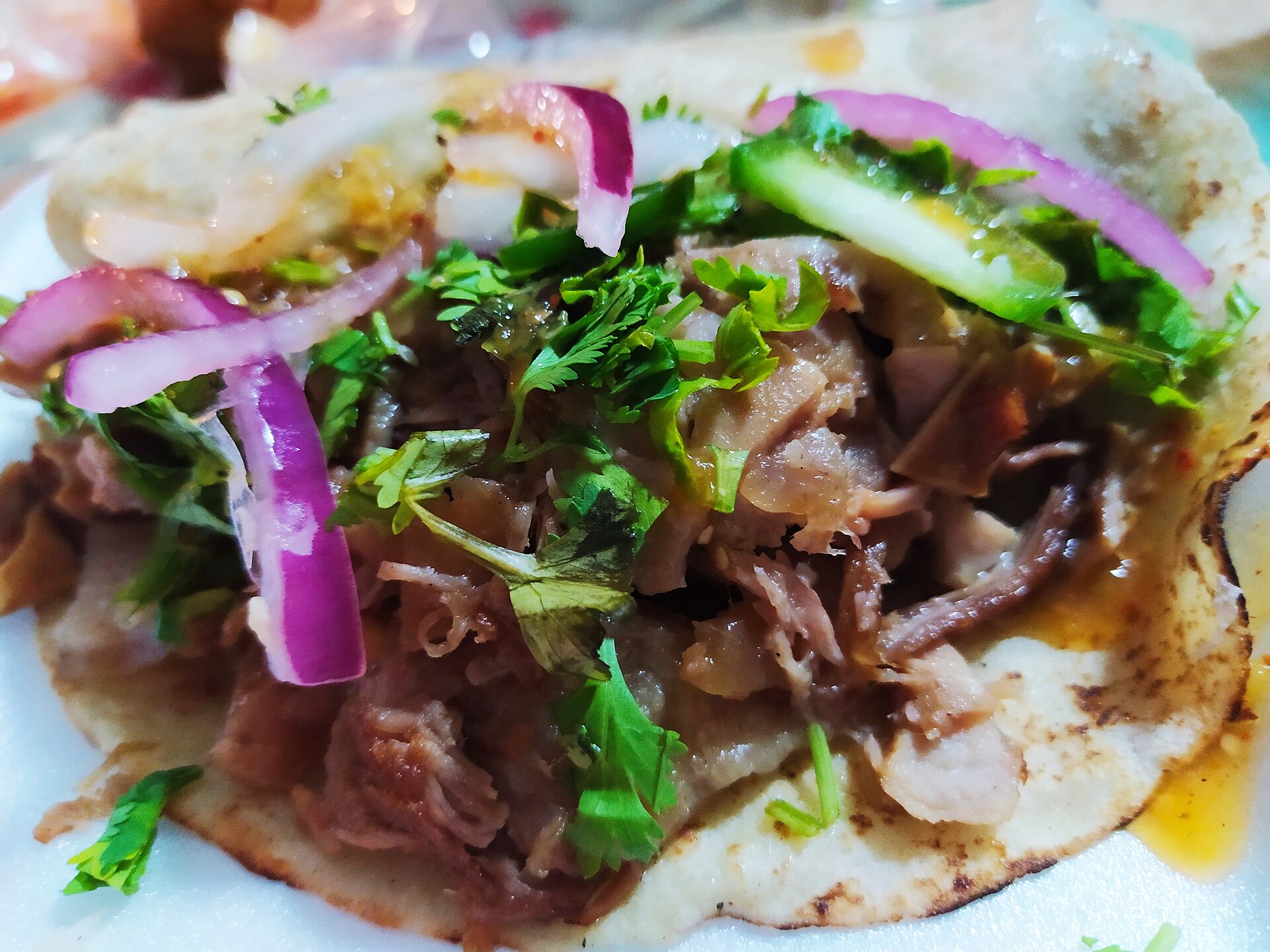 Illustrative photograph of carnitas pork taco in tortilla; not a photograph of Chevys Fresh Mex - Sacramento