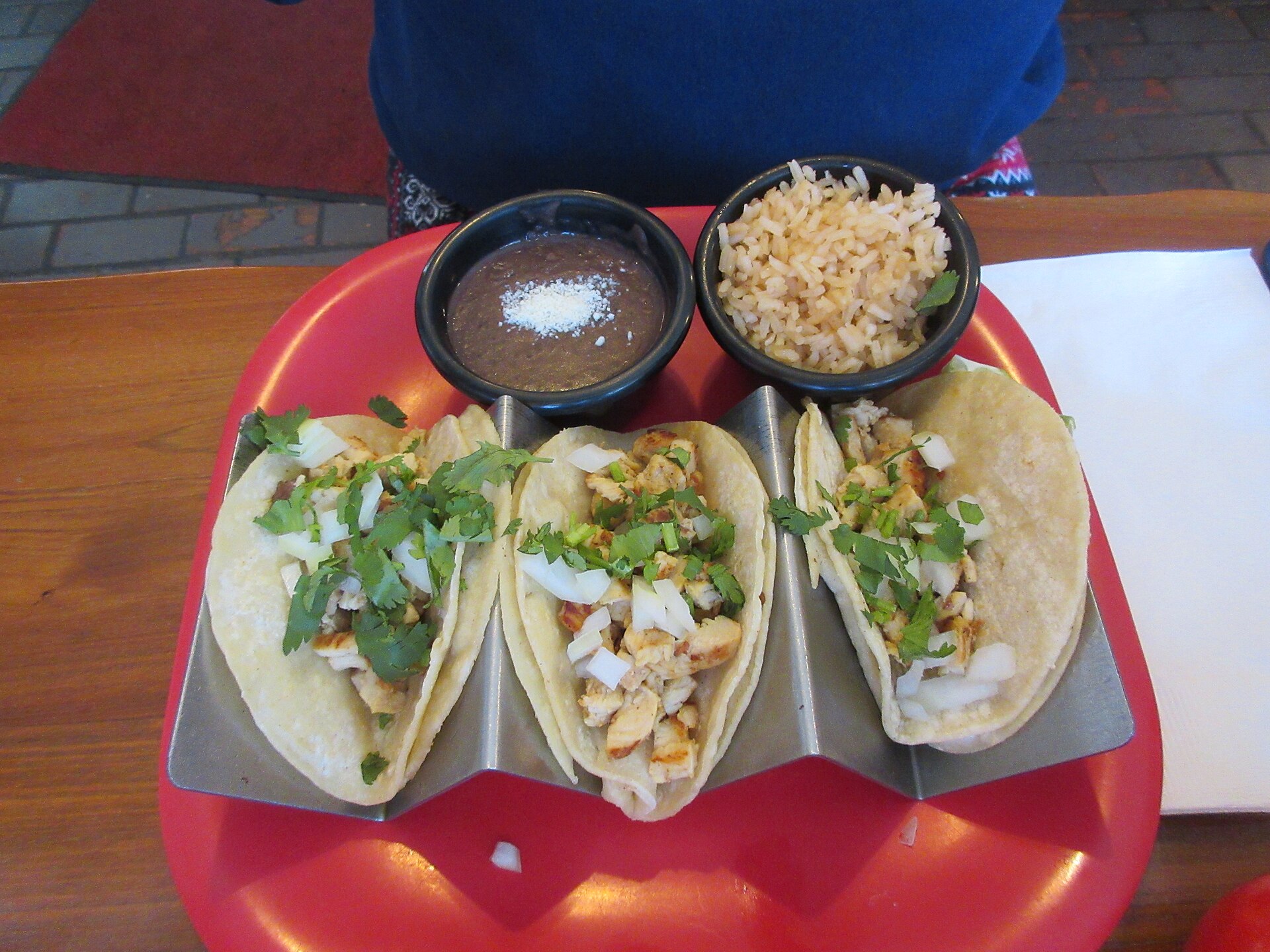 Illustrative photograph of chicken tacos served with toppings; not a photograph of VJ’s Bar & Burger
