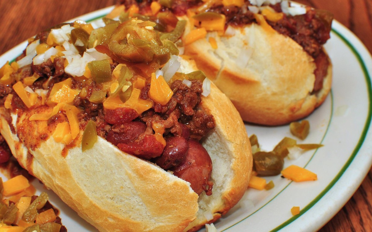 Illustrative photo of chili cheese dogs topped with beef chili and melted cheese; not photographed at Heritage Bar & Kitchen