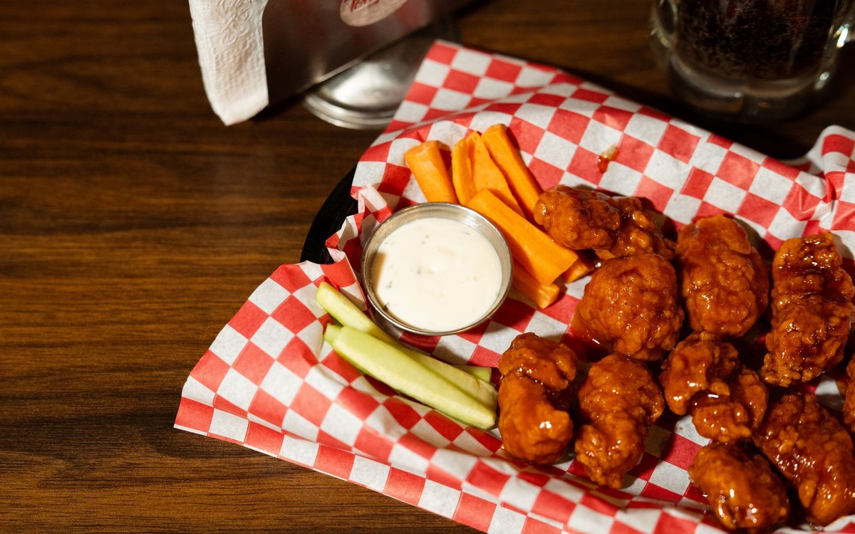 Illustrative photograph of crispy buffalo chicken wings with ranch dipping sauce; not taken at Poole’s Public House North