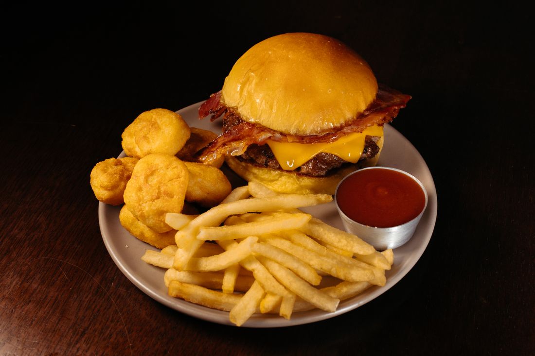 Illustrative hamburger with fries photograph — not a photograph from Famous Sam's on River