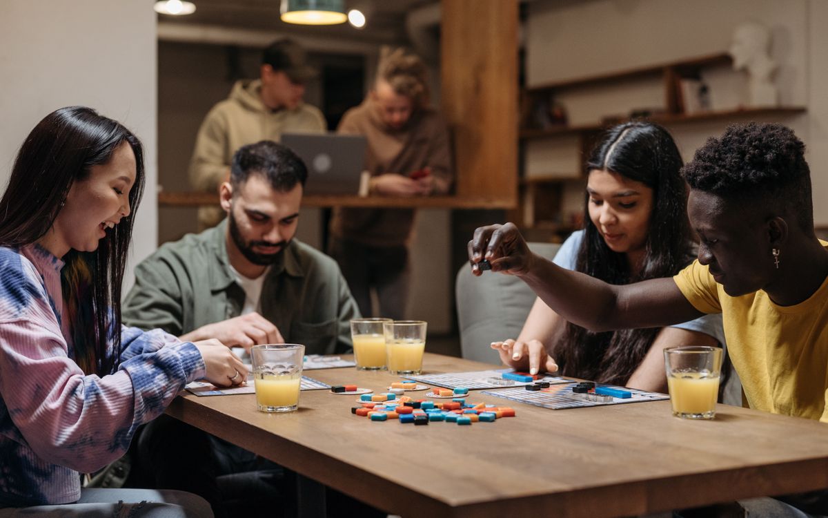Illustrative photo of a group of friends playing a table game together, not at this venue